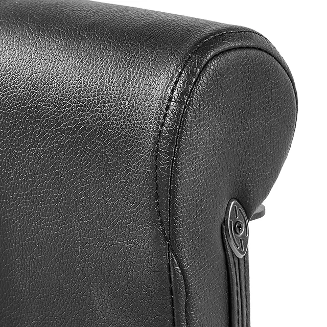 Close-up of a black leather bag with a textured surface resembling the ATX® Sissy Squat Stand, featuring a small circular metal hardware piece on the side attached by a strap.