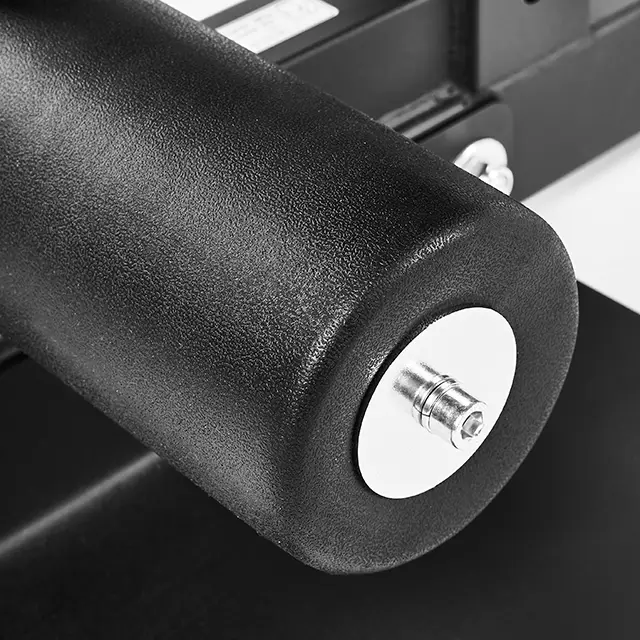 A close-up shows the black foam roller of the ATX® Sissy Squat Stand, with its cylindrical shape attached by a metal pin at one end, set against a dark background.