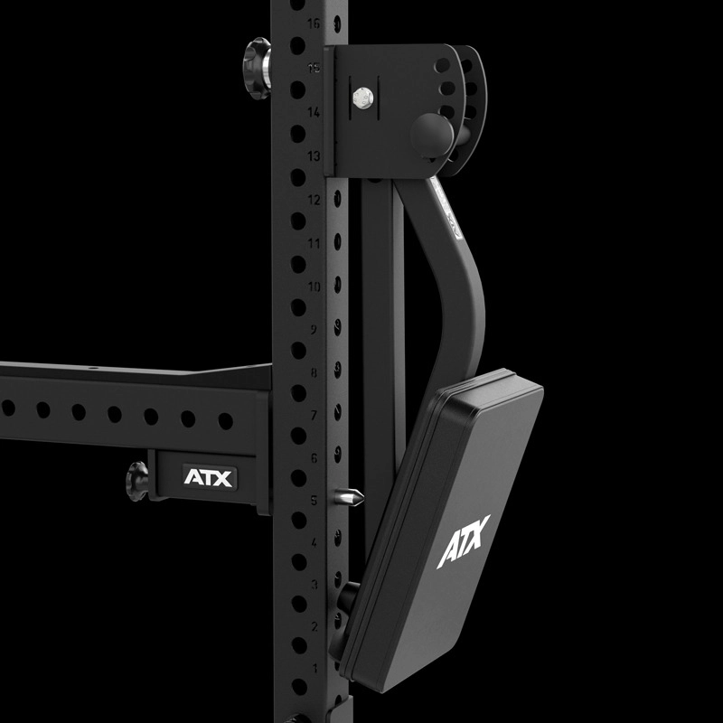 Close-up of the ATX® The Bridge Supporting Pad adjustable arm attachment, mounted on a steel power rack with multiple height adjustment holes, set against a black background.