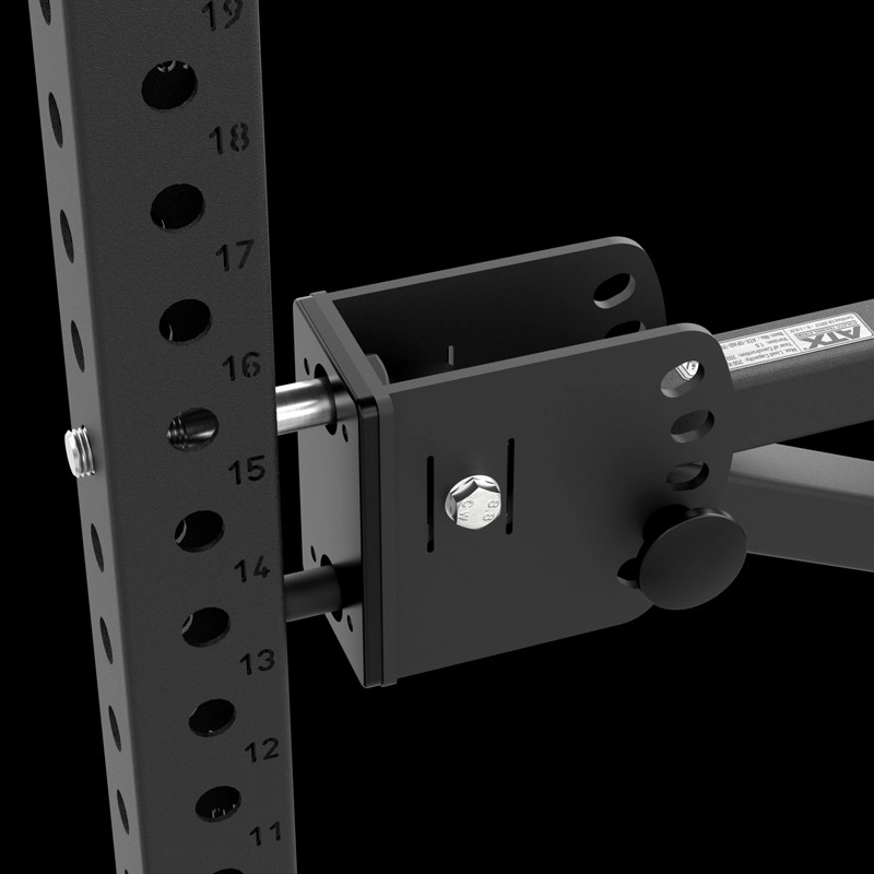 Close-up of the ATX® The Seal Row Pad, locked onto a black metal exercise rack with numbered adjustment holes, bolts, and knobs visible against a black background.