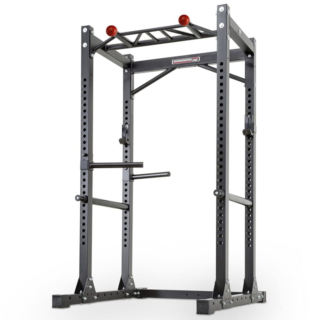 Introducing the Barbarian Commercial Power Cage: a black freestanding power rack with multiple adjustment holes, pull-up bars, and dip handles. Perfect for strength training exercises like squats and bench presses, it boasts a sturdy, industrial design built to withstand intense workouts.