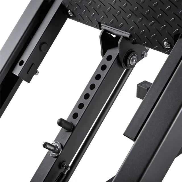 Close-up of adjustable metal components and mechanisms on the ATX® 45 Degree Leg Press, featuring position adjustment holes and a textured footplate.
