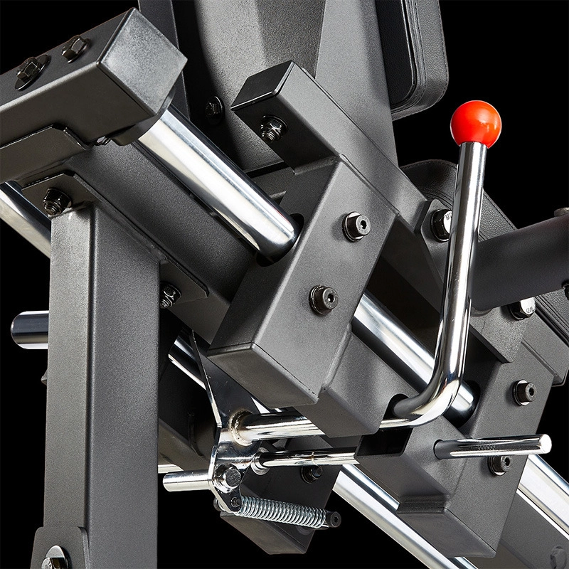 Close-up of the ATX® Compact Leg Press ATX-CLP-700’s adjustment mechanism, featuring metal bars, bolts, black frames, and a chrome lever with an orange handle set against a black background.