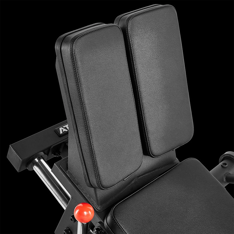 Close-up of the padded backrest and seat of the ATX® Compact Leg Press ATX-CLP-700, showing two vertical cushions and a red adjustment knob against a black background.