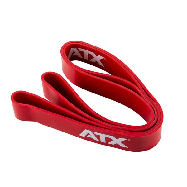 A red ATX® Power Band is folded in a loop with ATX printed in white on both sides. It is coiled neatly, highlighting its thick width and smooth texture.