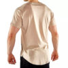 A person wearing a beige short-sleeve t-shirt and black pants, viewed from the back, stands against a plain white background. The t-shirt has a curved hem. The person has short hair and their hands are relaxed by their sides.
