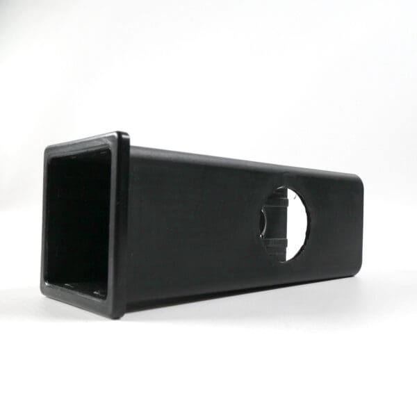 An Upright Sleeve Insert 40x40x120, a black, rectangular, hollow plastic object with a round cutout on its side, is shown against a plain white background.
