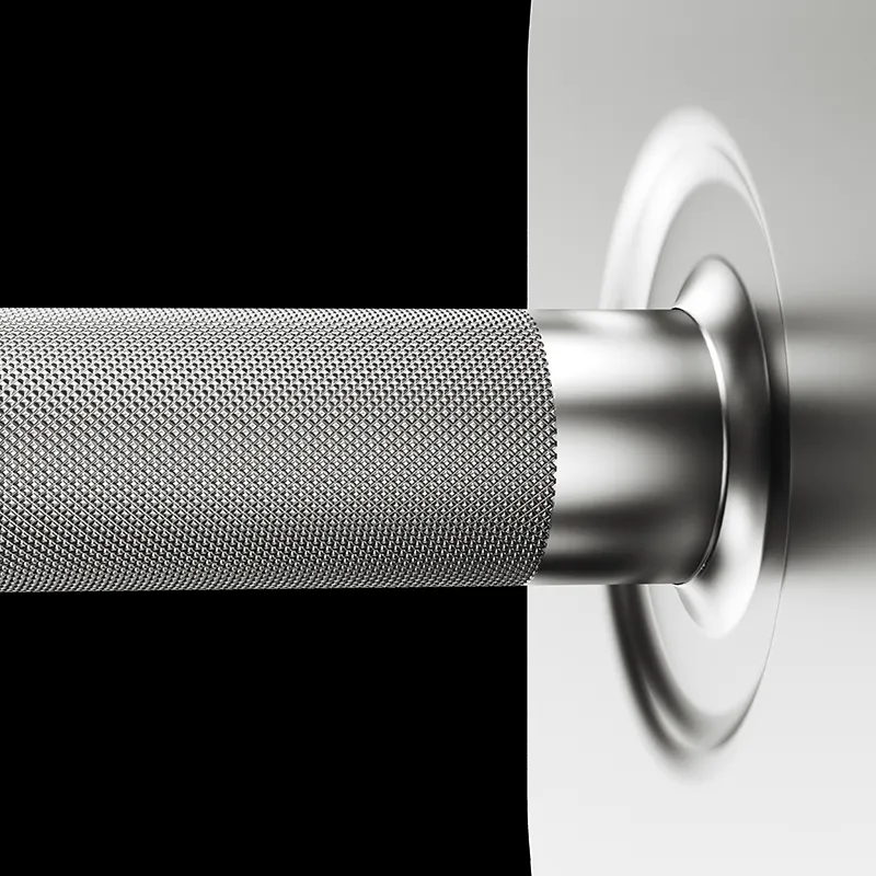 Close-up of the Ironmaster 75 LB Quick-Lock Adjustable Dumbbell handle, highlighting its knurling and one end inserted into a shiny circular weight plate, set against a black and gray background.