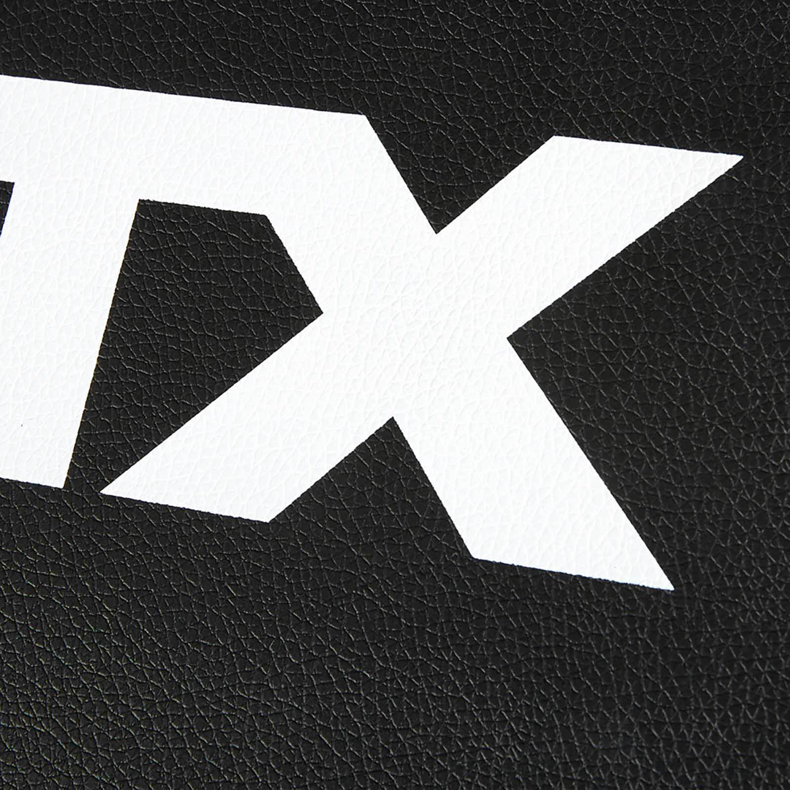 Close-up of a white, bold, partial letter X on a textured black surface, reminiscent of leather, as if carved into the robust material of a fid bench.