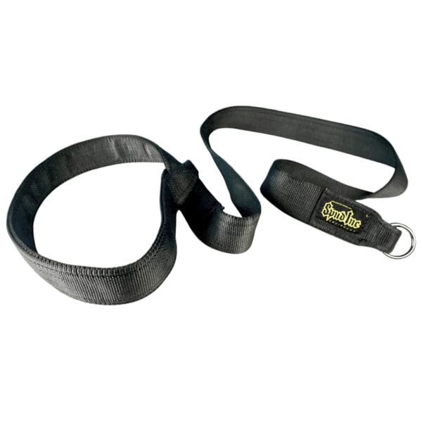 The Spud Inc One Sled Pulling Belty Strap is a black coiled fabric strap with multiple loops, featuring a yellow logo on one end and a metal ring.