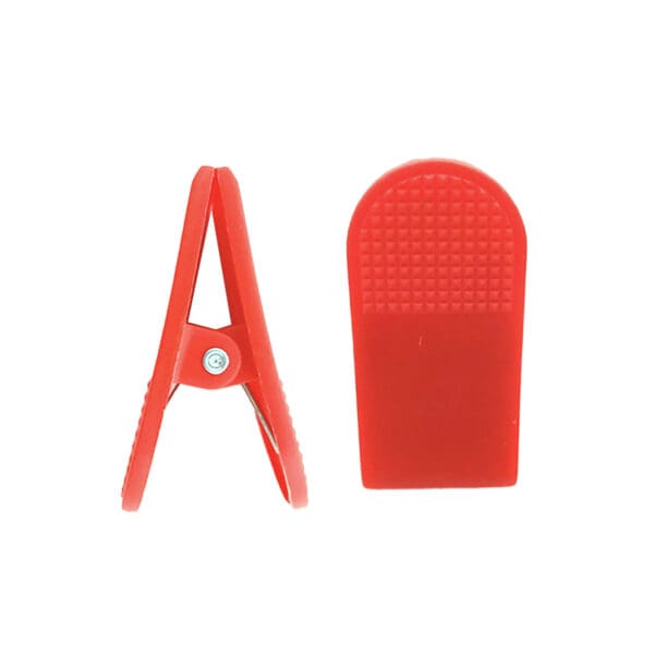 The Treadmill Safety Key Clip, in red plastic, is shown from two angles: a side view highlighting its hinge mechanism and another revealing its textured grip surface.