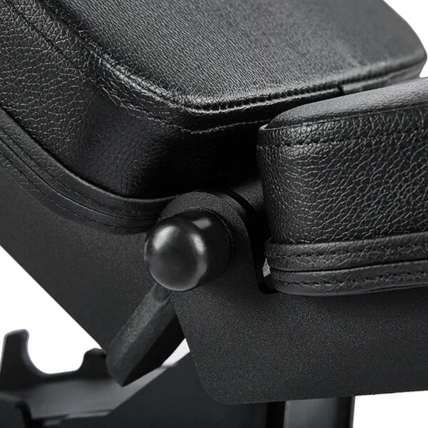 Close-up of the ATX® Warrior Bench 2.0s black leather adjustable backrest hinge, similar to gym weight benches. The seat and backrest join via a round, black knob, highlighting its textured upholstery and strong build.