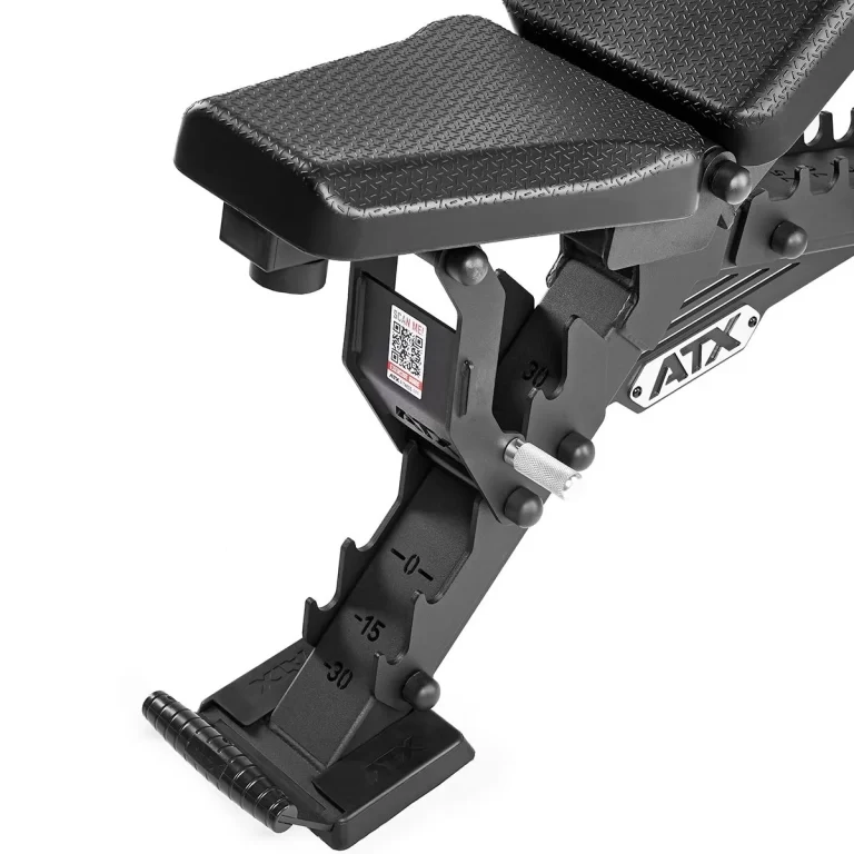 The ATX® Warrior Bench - Slim PU is shown in black with textured padding. It features a frame with angle measurements, a foot holder at the base, the ATX branding on the side, and a QR code near the seat adjustment mechanism.
