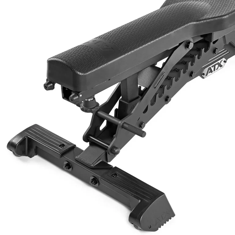 Close-up of the ATX® Warrior Bench - Slim PU, showcasing a textured seat and sturdy multi-position support frame with a visible logo. In the foreground is its stable, wide base.