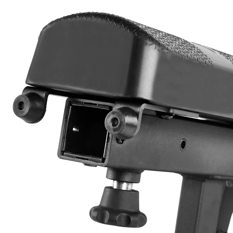 Close-up of the ATX® Warrior Bench - Slim PU in black, featuring an adjustable bicycle seat post with a plastic cover and metal components. It includes adjustment knobs and a frame cut-out, set against a plain white background.
