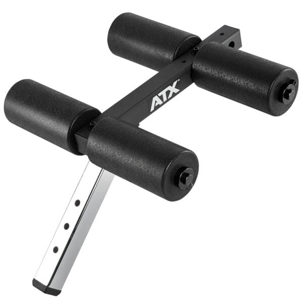 The ATX® AB Attachment is a black adjustable foam roller for a workout bench, featuring four cylindrical foam pads on a metal frame to support exercises.