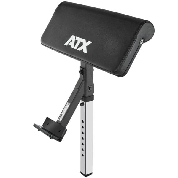 The ATX Bicep Curl Pad is an adjustable preacher curl attachment with a black padded armrest, featuring a metal frame with multiple height adjustment holes and a bracket for bench attachment.