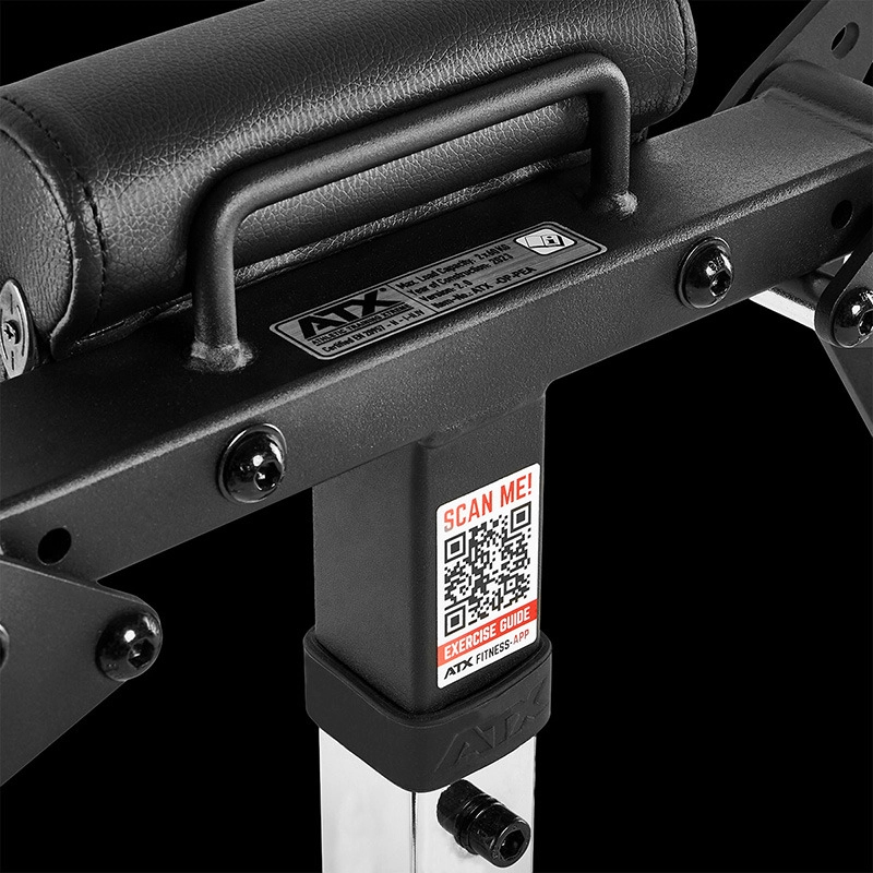 Close-up of a black and silver ATX® Pec-Fly Attachment with a padded handle, metal label, and a QR code sticker labeled SCAN ME! EXERCISE GUIDE on its vertical support, set against a black background.