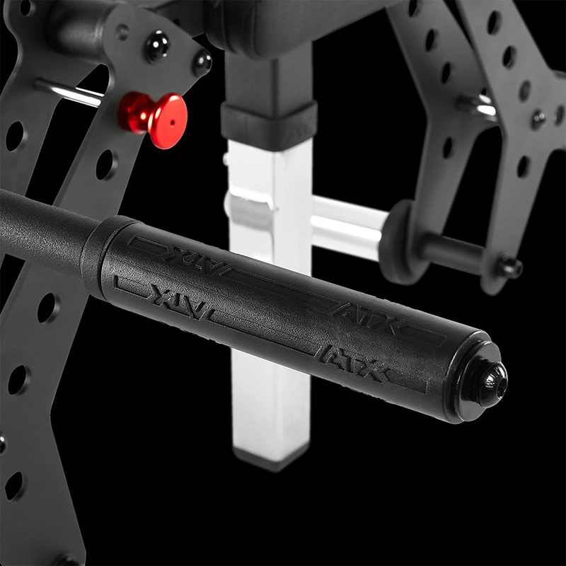 Close-up of a black textured handle with ATX branding, attached to the metal frame of the ATX® Pec-Fly Attachment with a red adjustment knob, set against a solid black background.