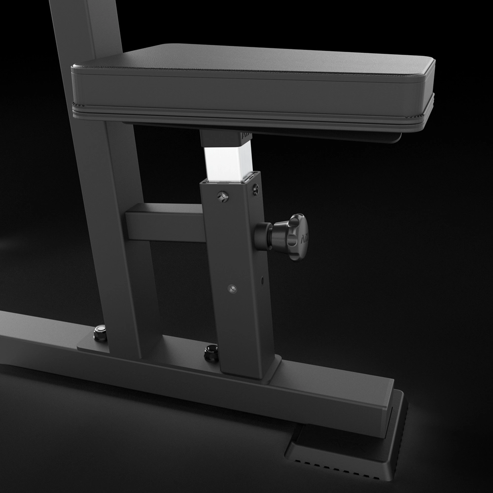 Close-up of the ATX® Pec Fly/Rear Delt Machine’s black adjustable gym bench, featuring a padded seat, sturdy metal frame, adjustment knob, and robust support structure against a dark background.