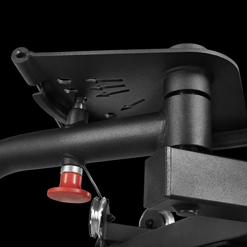 Close-up of the ATX® Pec Fly/Rear Delt Machine shows a black metal mechanism with a red push button and flat plate against a black background.