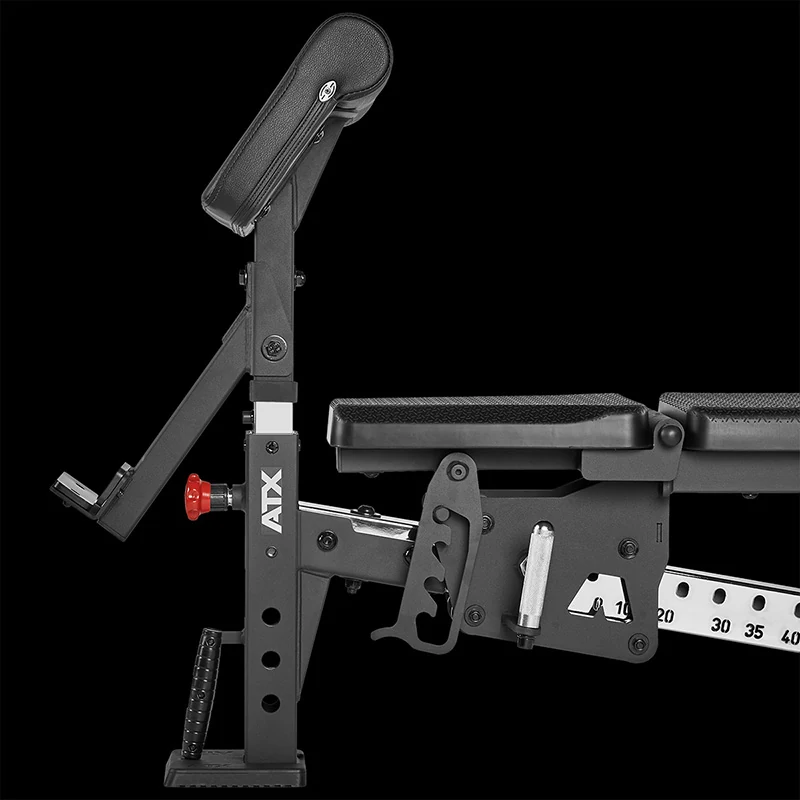 ATX Bicep Curl Pad attachment mounted to a weight bench, showing the height adjustment pin, angle locking mechanism, and a numerical indicator rail.