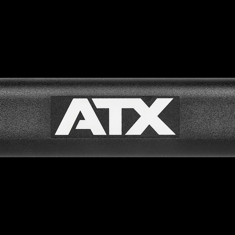 A close-up of the ATX® Cambered Swiss Bar 50mm, featuring a bold white ATX logo on its black surface against a black background.