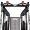 Close-up of a gym equipment structure with pull-up bars and handles. The machine has adjustable weights and an ATX logo, and features a chart illustrating different exercises.