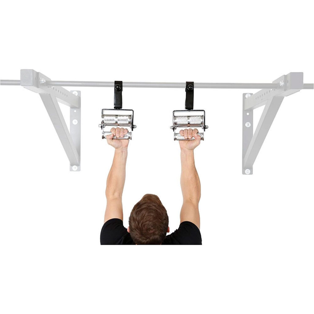 Wearing a black shirt, the person dangles from a wall-mounted pull-up bar utilizing two 3 Grip Chin Up Handles, their arms stretching upwards against the plain white backdrop.