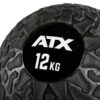 Close-up of an ATX® Slam Ball with a textured black surface and a rugged pattern. The brand ATX and weight 12 KG are displayed in white on its smooth circular patch.