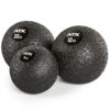 Three black ATX® Slam Balls, featuring white logos and weights of 4 kg, 12 kg, and 20 kg from left to right, with a textured pattern for enhanced grip.