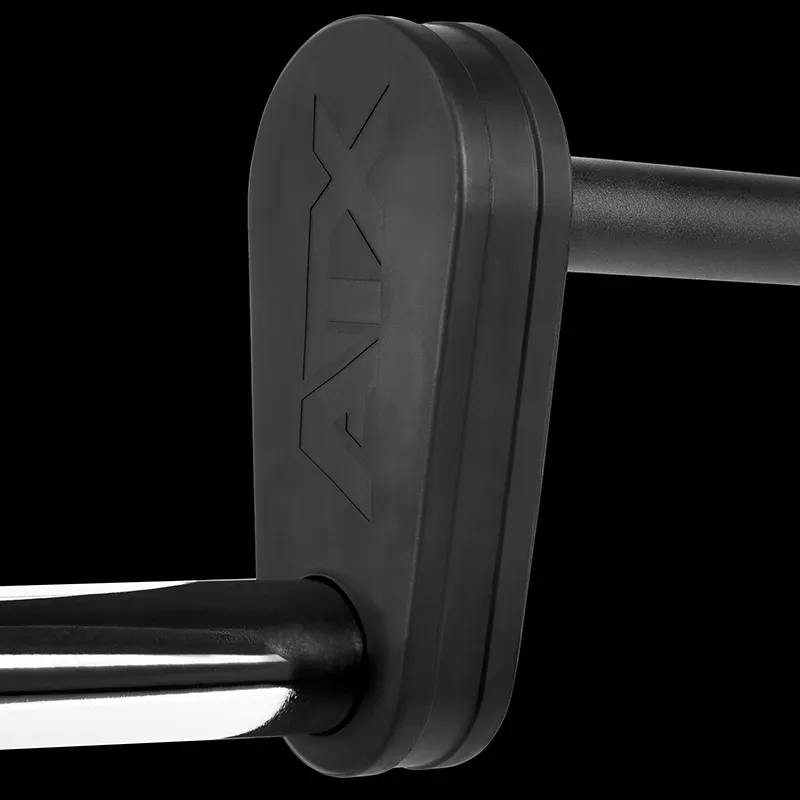 Close-up of the ATX® Safety Squat Bar - 50mm in black and silver metal, featuring a black rubber or plastic end cap labeled AUX, against a black background, with focus on the end cap and part of the bar.