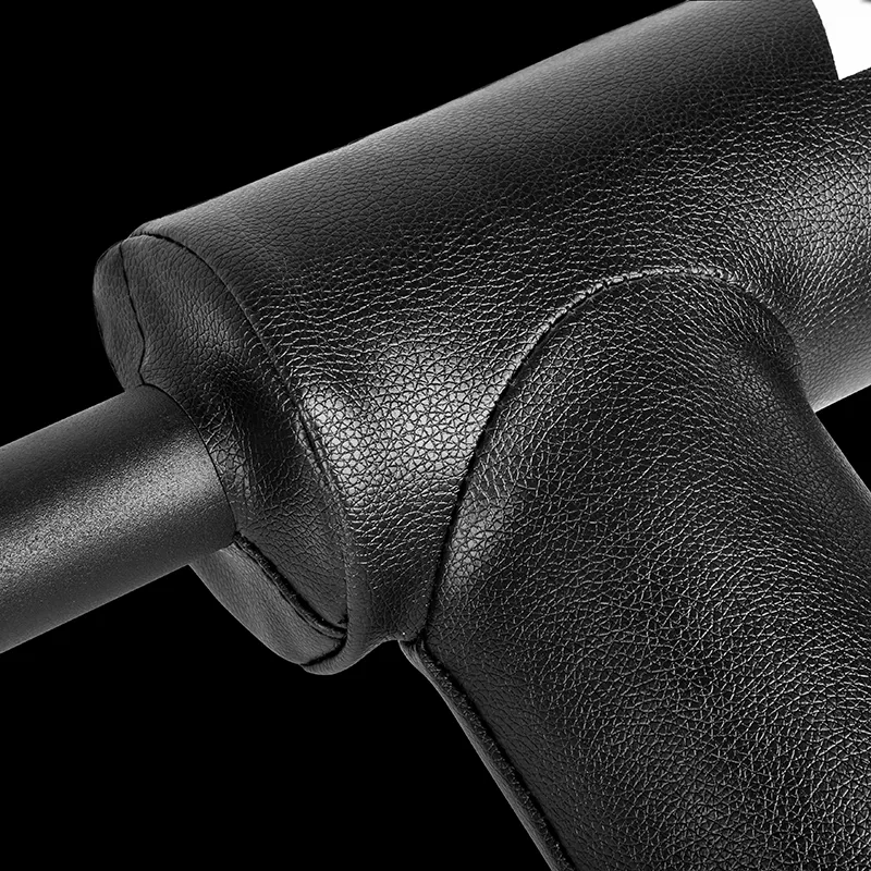 Close-up of the padded black leather handlebar cover with textured stitching on the ATX® Safety Squat Bar - 50mm, wrapped around a metal bar against a solid black background.