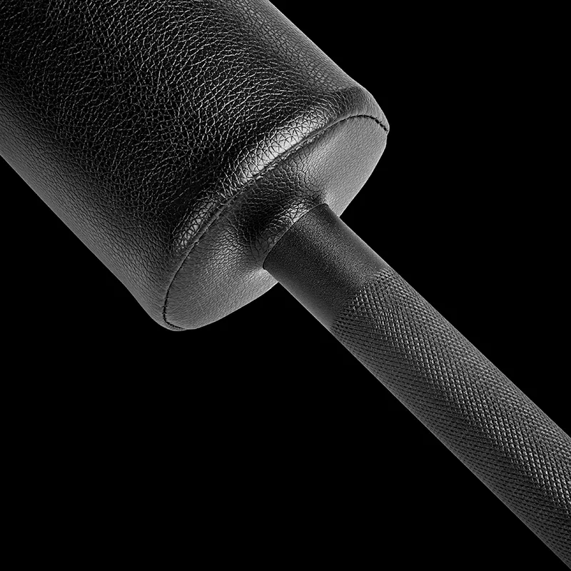 Close-up of the ATX® Safety Squat Bar - 50mm, featuring a textured black leather cylindrical pad on a knurled metal handle, set against a black background.