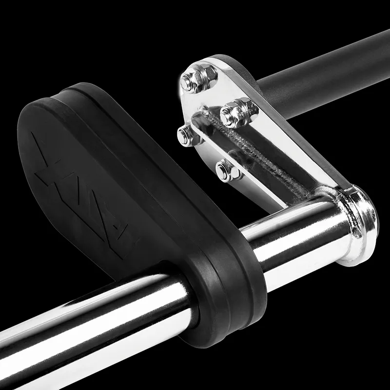 Close-up of the ATX® Safety Squat Bar - 50mm with black rubber stoppers and a chrome bracket against a black background, highlighting gym equipment details.