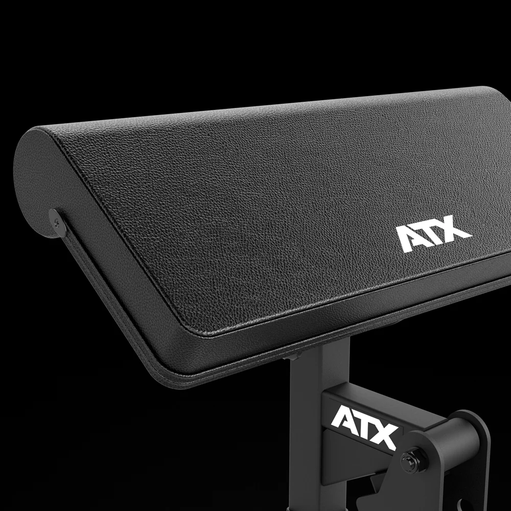 Close-up of the wide curved arm pad on the ATX Biceps Curl Attachment with the white ATX logo on a black background