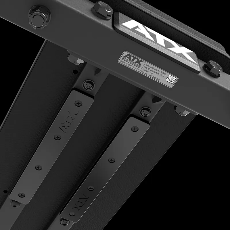 Close-up of the black metal ATX® Seal Row Bench frame, highlighting bolts, support beams, and a manufacturer label attached to its structure.