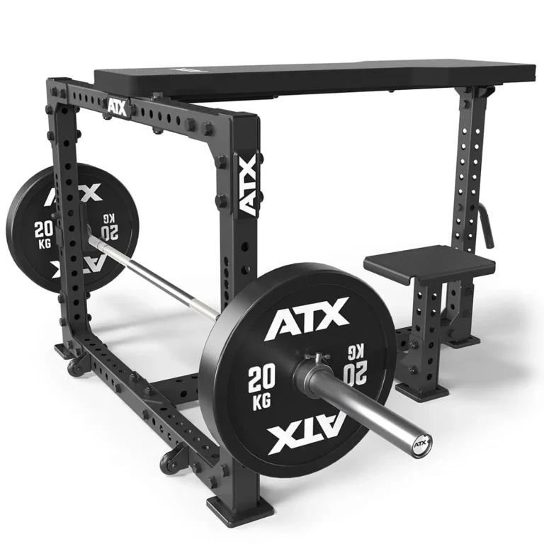 A black ATX power rack with adjustable features includes a barbell loaded with 20 kg weights on each side. The sturdy steel frame and bench seat attachment make it perfect for exercises like the Seal Row Bench. The ATX logo enhances quality and design on both the weights and rack.