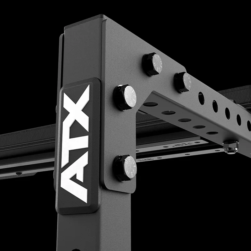 Close-up of the black ATX® Seal Row Bench featuring the white ATX logo, bolts, and adjustable holes on a horizontal bar, all set against a black background.
