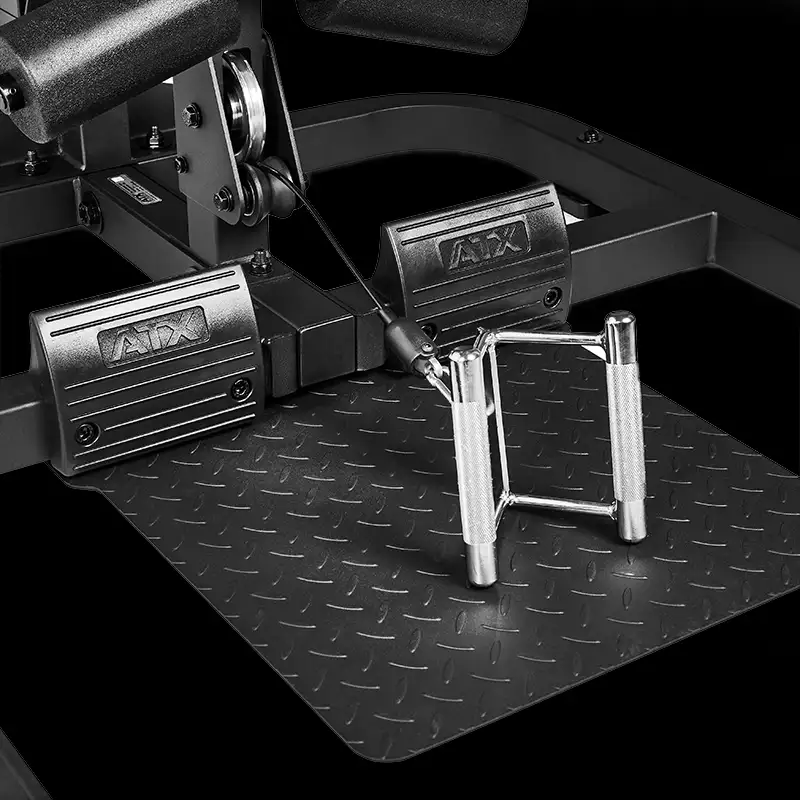 Close-up of the ATX® Triplex Weight Stack Gym footplate featuring a diamond-patterned surface, two ATX-branded footrests, and a chrome double D row handle attached to a cable for seated rowing exercises.