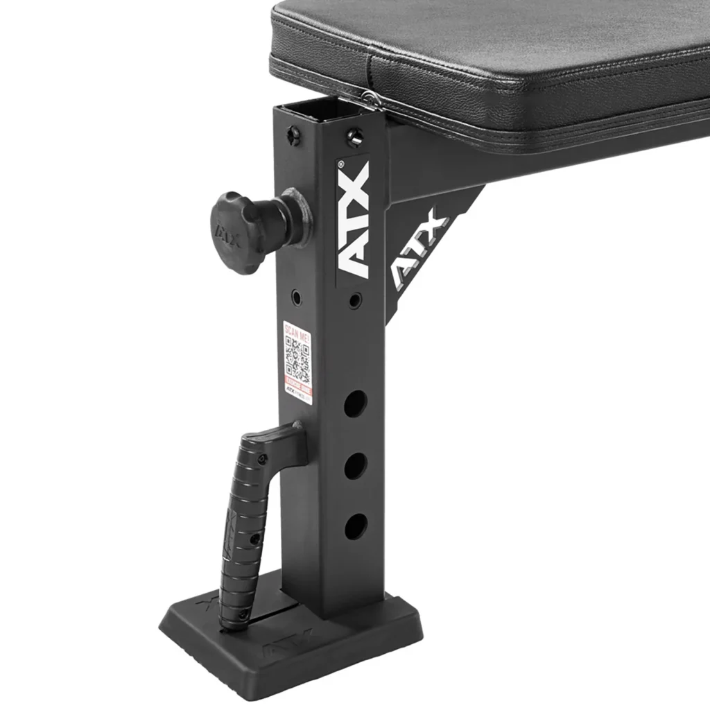 The adjustable frame of the ATX® Flat Workout Bench Attachment showcases several adjustment holes, a handle, and the ATX brand name on its side. The padded bench top is perfect for flat weight lifting sessions.