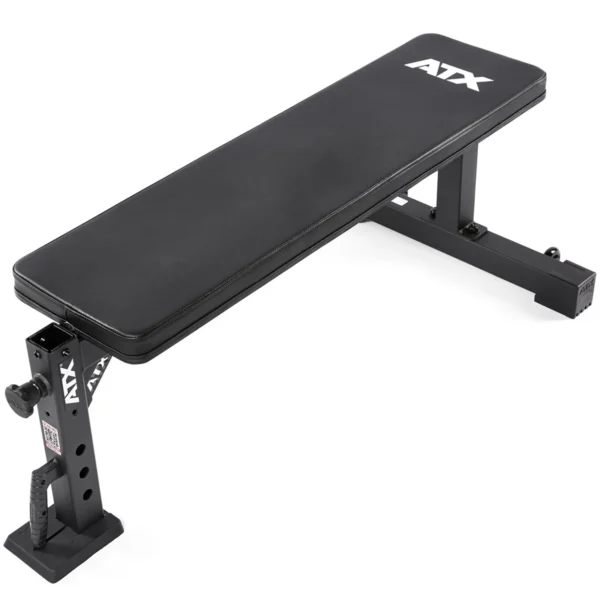 The ATX® Flat Workout Bench Attachment is a black flat weight bench with the ATX logo on its padded surface. It features an adjustable metal frame and two sturdy legs, making it ideal for strength training exercises and perfect for fitness enthusiasts.
