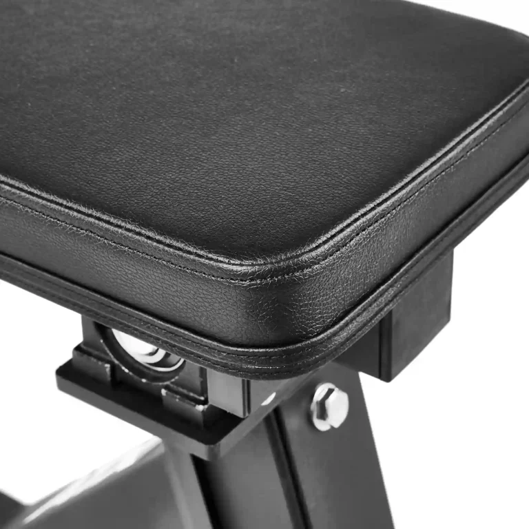 Close-up of a padded black leather bench with visible stitching, part of the sturdy metal support frame of the ATX Calf Raise Machine.