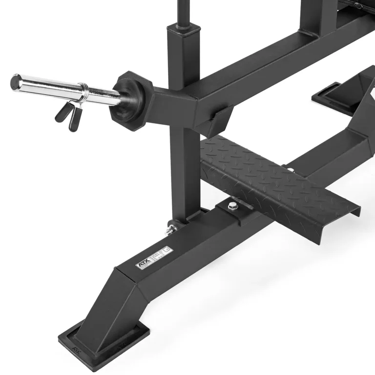 Close-up of a black calf raise machine frame with a silver attachment bar and a textured step plate. The frame is supported by a sturdy base, ideal for intense workouts.