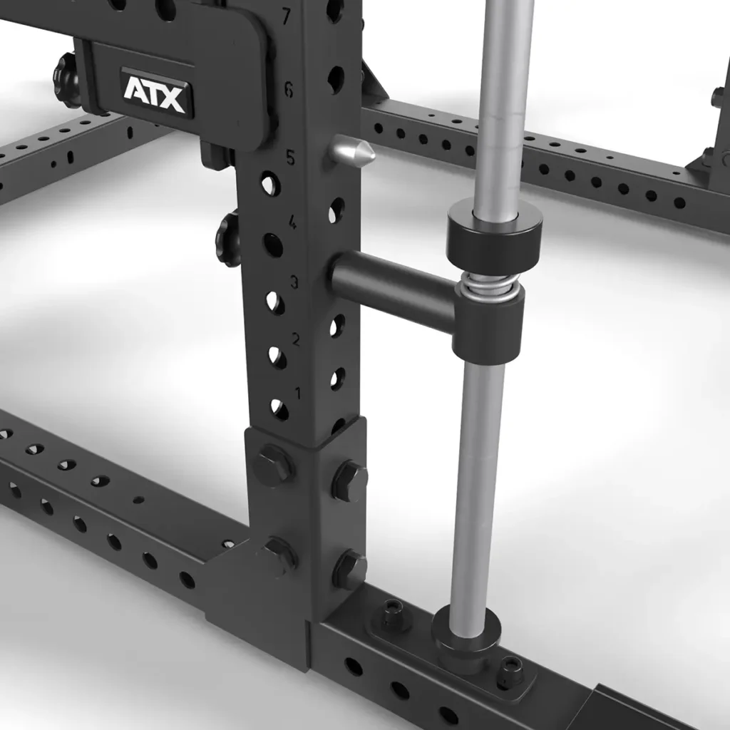 Close-up of the ATX® Smith Machine Bar Attachment - PRX-780 in black metal with adjustable positions. A silver barbell, held by thick black clamps, is set against a pristine white background.