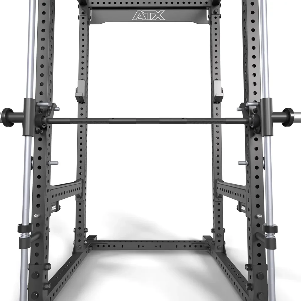 The ATX® Smith Machine Bar Attachment - PRX-780 enhances a sturdy black metal power rack with adjustable safety bars and weight holders. Ideal for strength training and weightlifting, set against a clean white background, it adds versatility to any fitness space.