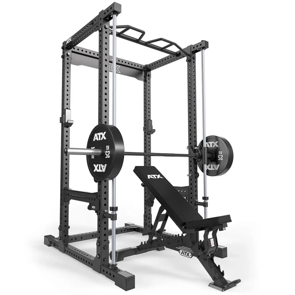 The ATX® Smith Machine Bar Attachment - PRX-780, in black, includes a bench press setup with a barbell and weights. It features multiple adjustable height options, an upper pull-up bar, and an angled white bench for versatile use against a white background.