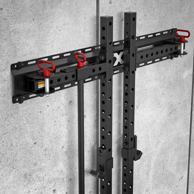 The ATX® Folding Squat Rack 500, in black metal, features adjustable holes, red locking pins, and multiple attachment points, all wall-mounted for a streamlined, space-saving fitness routine.