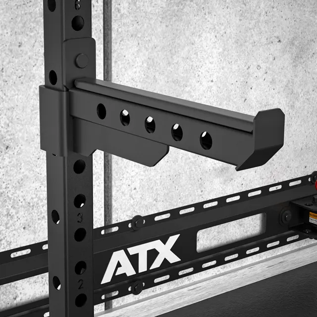 The ATX® Folding Squat Rack 500 is a black metal rack with holes, providing sturdy support and convenient storage for your workouts.
