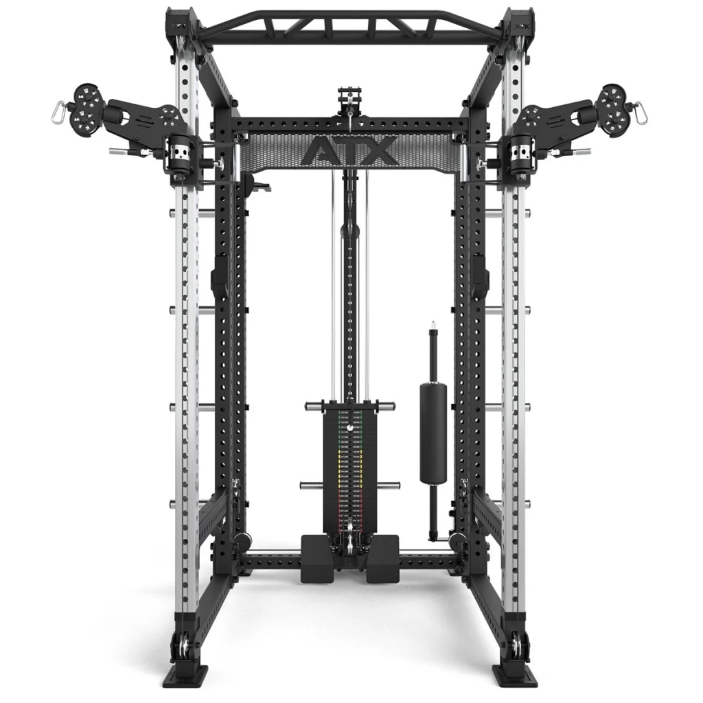 Front view of the ATX® Power Cage with Cables, featuring adjustable pulleys, weight stack, pull-up bar, and various attachments for strength training. The mostly black design includes metallic accents.